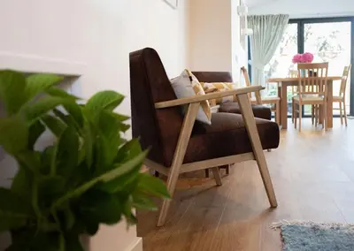 a living room with a chair and a table at 3 Bedroom House with Courtyard Garden and Parking in Chesterton