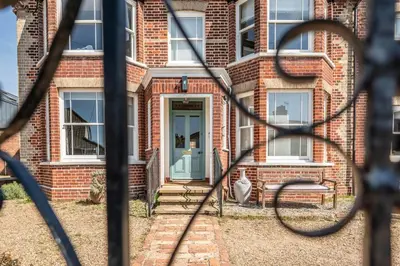 a brick house with a blue front door at Rosebank, a stunning holiday home in Aldeburgh in Aldeburgh