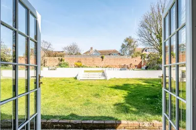 an open window with a view of a yard at Rosebank, a stunning holiday home in Aldeburgh in Aldeburgh