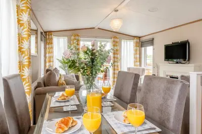 a dining room with a table with orange juice at 2 Bed in Welney oc-s29764 in Welney
