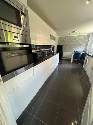 a kitchen with white cabinets and a stove top oven at Luxurious 3 Bedroom Contractor House Stevenage by Randz Property Group - Short Lets l Sleeps 6 l Free Parking & Wifi in Stevenage