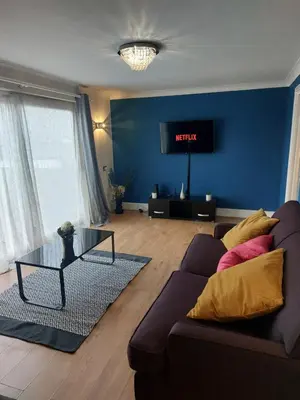 a living room with a couch and a tv at Luxurious 3 Bedroom Contractor House Stevenage by Randz Property Group - Short Lets l Sleeps 6 l Free Parking & Wifi in Stevenage
