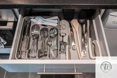 a drawer filled with silver utensils in a kitchen at Jardine House in Colchester