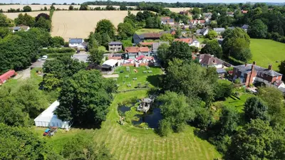 an aerial view of a village with a park at The Bell Inn in Wendens Ambo