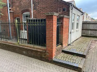 a brick building with a gate and a fence at 7a Sir Alf Ramsey Way in Ipswich