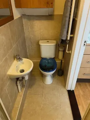 a small bathroom with a toilet and a sink at 7a Sir Alf Ramsey Way in Ipswich