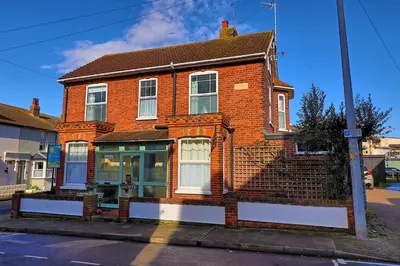 a red brick house on the side of a street at Walton Beach Holiday Lets in Walton-on-the-Naze