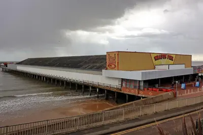 a pier with a seafood restaurant on the beach at Walton Beach Holiday Lets in Walton-on-the-Naze