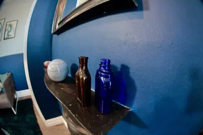 two bottles sitting on a shelf in a room at Stylish and artistic flat in Southend on Sea - 2 Double Bedrooms, Free on-street parking in Southend-on-Sea