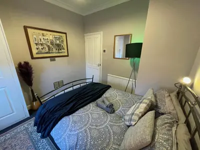 a bedroom with a bed with an umbrella on it at Stylish and artistic flat in Southend on Sea - 2 Double Bedrooms, Free on-street parking in Southend-on-Sea