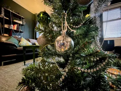 a christmas tree with ornaments on it in a living room at Stylish and artistic flat in Southend on Sea - 2 Double Bedrooms, Free on-street parking in Southend-on-Sea