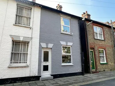 a gray and white house on the side of a street at Cottage in Walton on the Naze in Walton-on-the-Naze