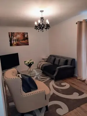 a living room with a couch and a table at Homely Space in Havering, Essex in Havering atte Bower