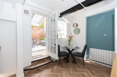 a dining room with a table and chairs at Central Medieval Grid Unique home with Gated parking in Bury Saint Edmunds