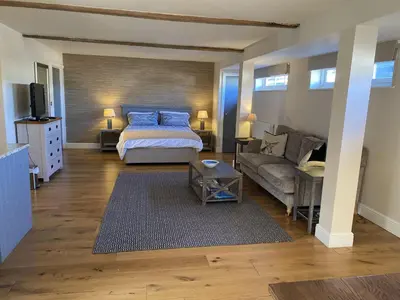a bedroom with a bed and a couch at Red lion little barn in Ipswich
