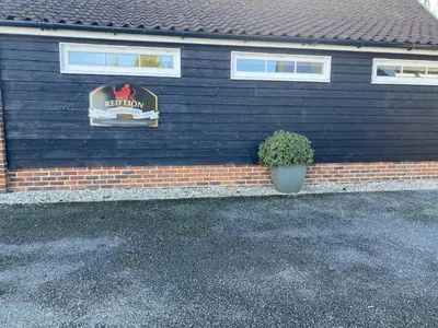 a house with a sign on the side of it at Red lion little barn in Ipswich