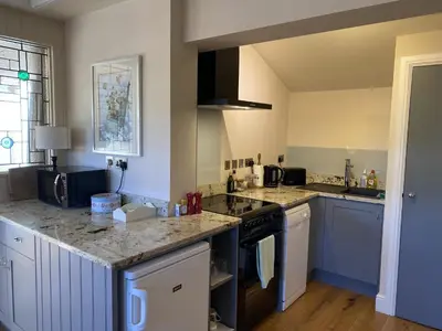 a kitchen with a sink and a stove top oven at Red lion little barn in Ipswich