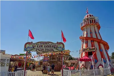 a carnival with a ferris wheel and a ride at 3 Bed Caravan Sleeps 8 - Parking Bbq Pool in Clacton-on-Sea