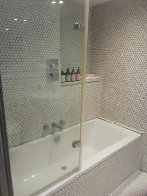 a bathroom with a bath tub and a shower at Five Acre Barn in Leiston