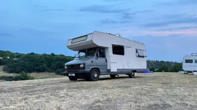 a white camper truck parked in a field at Surfer Mammut in Ipswich