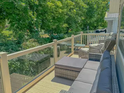 a view of a deck with a couch on a porch at Platinum lakeside Lodge on resort with fishing in Kelsale