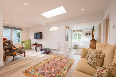 a living room with a couch and a table at The Whins, Aldringham in Aldringham