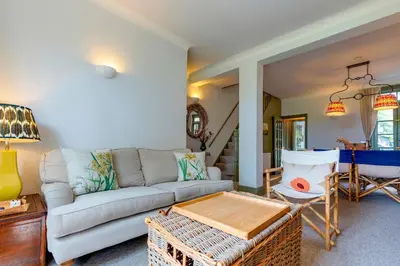a living room with a couch and a table at Pass the Keys Charming Victorian Terrace in centre of Cambridge in Cambridge