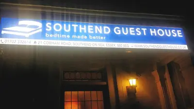 a sign for a guest house on the side of a building at Southend Guest House - Close to Beach, Train Station & Southend Airport in Southend-on-Sea
