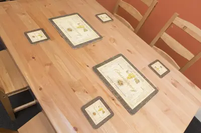a wooden table with framed pictures on it at Southend Guest House - Close to Beach, Train Station & Southend Airport in Southend-on-Sea