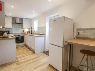 a kitchen with white appliances and a white refrigerator at Pear Tree Cottage in Swaffham