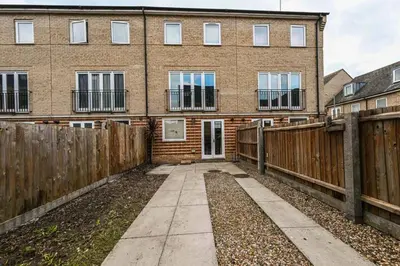 a brick building with windows and a fence at Harland Haven Spacious 4br House In Ipswich in Ipswich