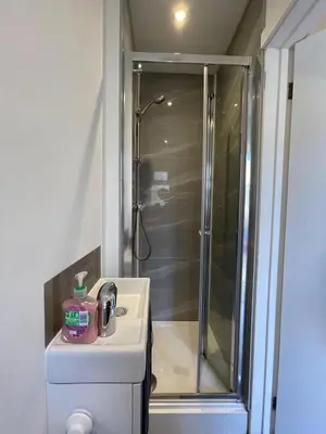 a bathroom with a shower and a sink at 63 studio room for single or double occupancy in Brentwood