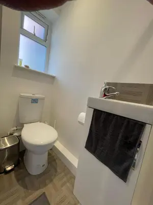 a bathroom with a toilet and a black towel at 63 studio room for single or double occupancy in Brentwood