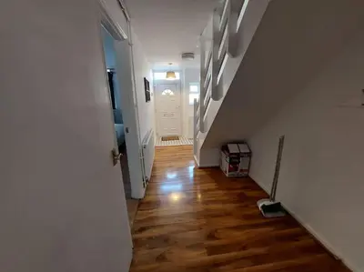 an empty hallway with a stairway leading to a room at 5 Bedroom House in Romford in Harold Wood