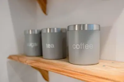three coffee cups sitting on a wooden shelf at Ipswich Marina1 2 bed2bath apt in Ipswich