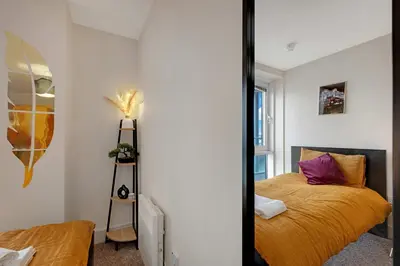 a bedroom with a bed and a mirror at Ipswich Marina1 2 bed2bath apt in Ipswich