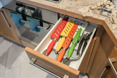 a drawer in a cabinet filled with utensils at Ipswich Marina1 2 bed2bath apt in Ipswich