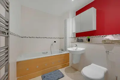 a bathroom with a tub and a toilet and a sink at Ipswich Marina1 2 bed2bath apt in Ipswich