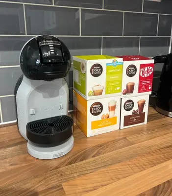 a coffee maker and a box on a counter at The Nook - Town Centre Apartment in Hoddesdon