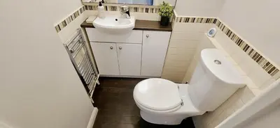a small bathroom with a toilet and a sink at Chelmsford Comfort Retreat Spacious 4 Bedroom Sleeps 7 Free Parking in Widford