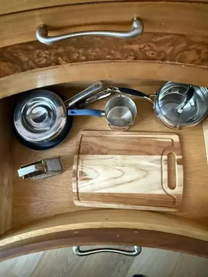 a wooden table with some utensils on it at One Granary Barns near Stansted Airport in Elsenham