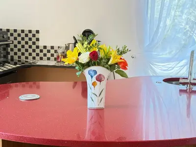 a vase filled with flowers sitting on a table at One Granary Barns near Stansted Airport in Elsenham