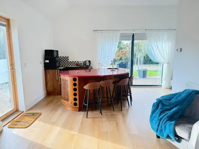 a kitchen with a table and chairs in a room at One Granary Barns near Stansted Airport in Elsenham