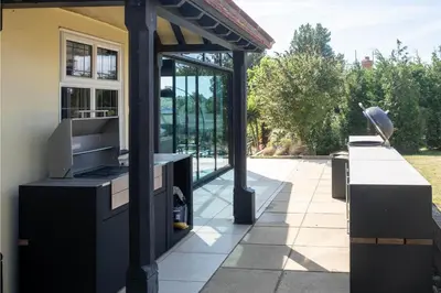 a house with a kitchen and a patio at Mill House in Thorpeness