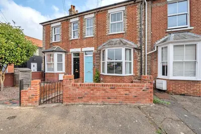 a red brick house with a blue door at Delightful 10 St Martins - 2 bed, 2 bathroom with parking available in Bury Saint Edmunds