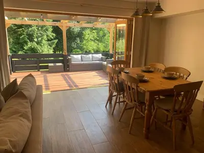 a living room with a table and chairs and a couch at Tasburgh - Farthings in Norwich