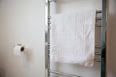 a towel hanging on a towel rack in a bathroom at The Palm Tree House in St Ives