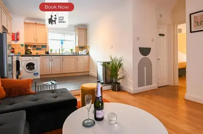 a living room with a couch and a table at Quiet Premium Stansted Apartment in Central Location with WiFi and Desk in Stansted Mountfitchet