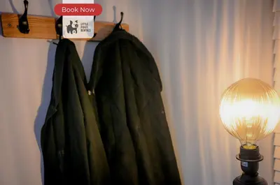 a green robe hanging on a rack next to a lamp at Quiet Premium Stansted Apartment in Central Location with WiFi and Desk in Stansted Mountfitchet