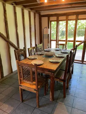 a wooden dining room table with chairs and a tableastery at Kings Barn - English Countryside Retreat in Lindsell